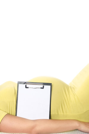 Happy pregnant girl lies on white backgroundの写真素材