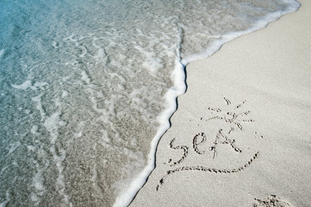 beautiful drawings on the sand of the sea shoreの写真素材