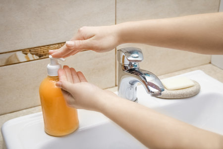Hands with soap are washed under the tap with water. Clean from infection and dirt and virus. At home or in the hospital ablution office.の写真素材