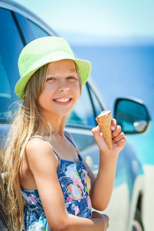 happy child with ice cream by the sea on weekend travel shoreの写真素材