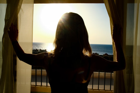 Beautiful girl at the time of the sea silhouette backgroundの写真素材