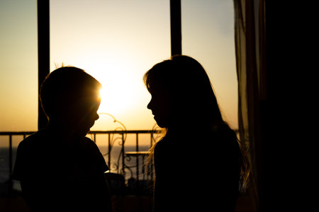 Happy children silhouette from room at sea travelの写真素材