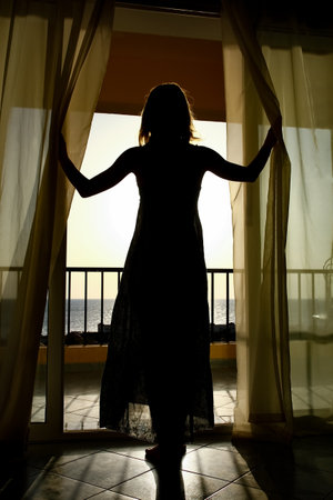 Beautiful girl at the time of the sea silhouette backgroundの写真素材