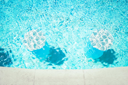 Beautiful swimming pool at the seaside hotel in park backgroundの写真素材