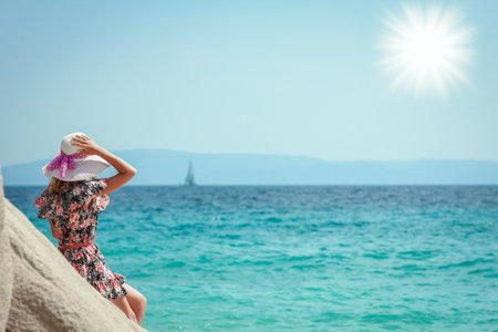Happy girl on the shore of the sea in travel vacationの写真素材