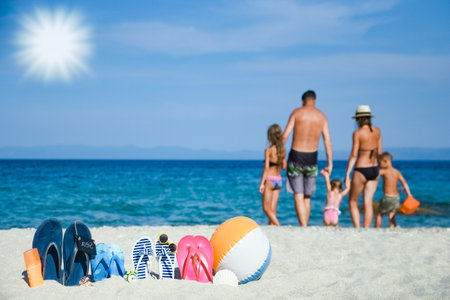 happy family on the sea with slippers on nature backgroundの写真素材