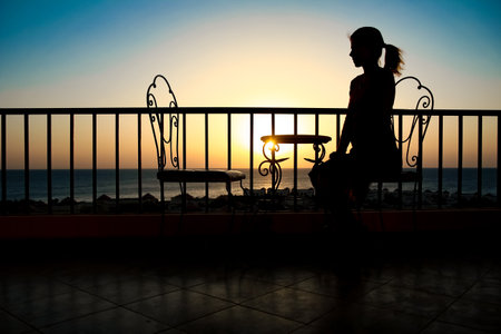 Beautiful girl at the time of the sea silhouette backgroundの写真素材