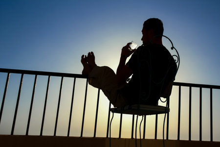 Happy guy silhouette on the background of nature backgroundの写真素材