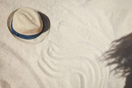 Stylish beautiful hat on the sand shore of the sea backgroundの写真素材