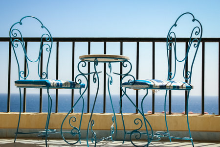 Beautifully stylish table chairs on the sea shore backgroundの写真素材