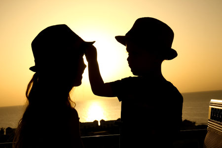 Happy child in hat silhouette on sea backgroundの写真素材
