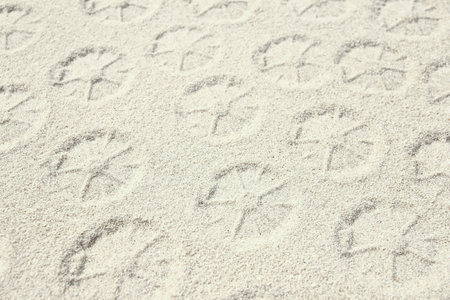 drawing on the sand by the sea travel backgroundの写真素材