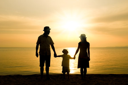 happy family in nature by the sea on a trip silhouetteの写真素材