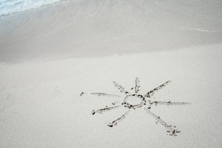 beautiful drawing on the sand near the sea shore backgroundの写真素材