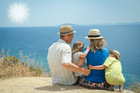 happy family taking a selfie by the sea on a tripの写真素材