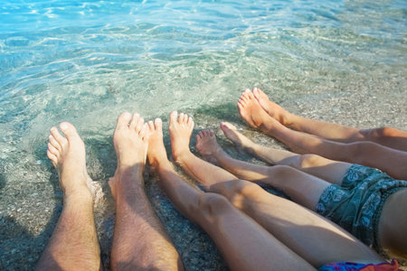 beautiful legs on the sand by the seaの写真素材
