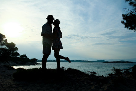happy couple by the sea on nature in travel silhouetteの写真素材