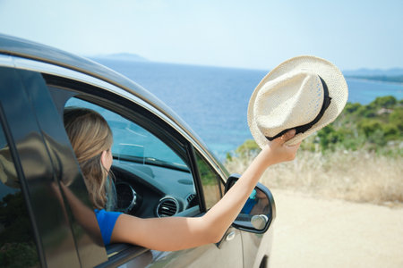 happy girl from car at sea greece backgroundの写真素材