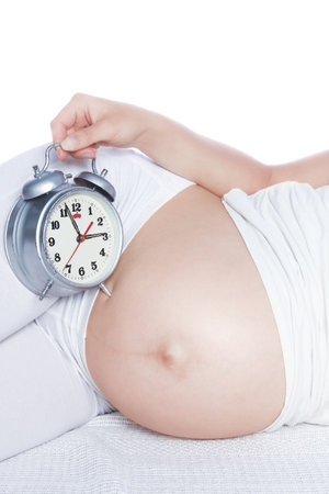 Happy pregnant girl lies on white background