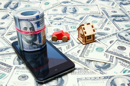 business dollar money from home by car and a telephone on a white backgroundの写真素材