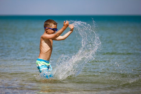 Happy child playing in the sea swim in natureの写真素材