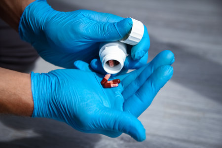 pills in the hands of the patient the concept of treatment and healthの写真素材