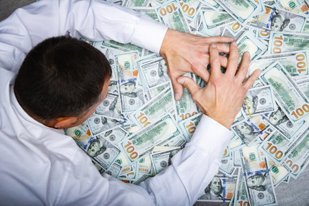 Happy guy with money in his hands for the development of shopping business and a great tripの写真素材