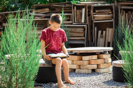 happy boy reading the bookの写真素材