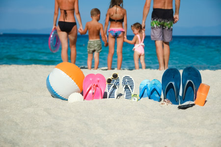 happy family on the sea with slippers on nature backgroundの写真素材