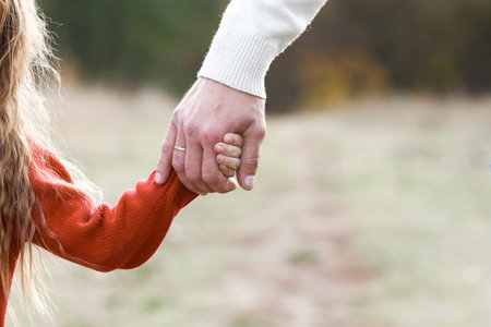 happy father holding child's hand concept family support relationsの写真素材