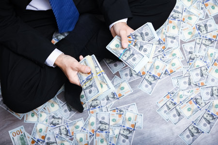 Happy guy with money in his hands for the development of shopping business and a great trip