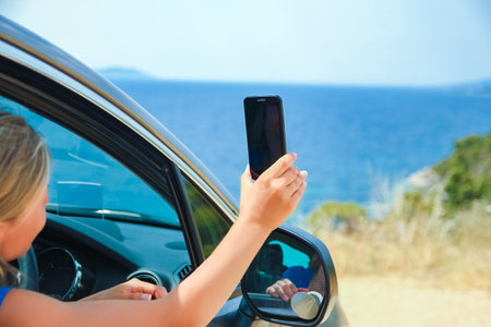 happy girl from car at sea greece backgroundの写真素材