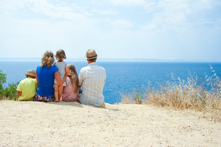happy family taking a selfie by the sea on a tripの写真素材