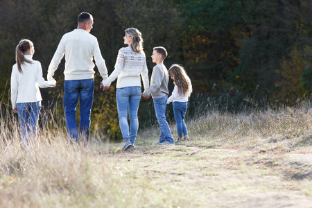 happy family walking in the park in autumn concept together happinessの写真素材