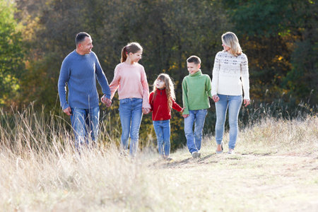 happy family walking in the park in autumn concept together happinessの写真素材