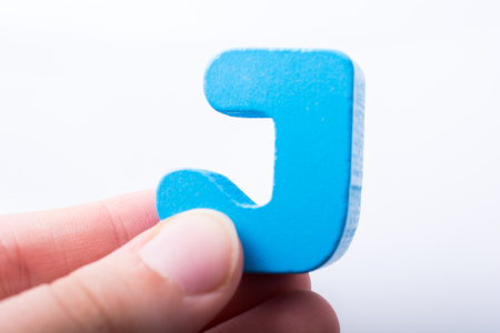 Hand holding Letter cube  J of  Alphabetの写真素材