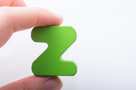 Hand holding letter cube Z of made of woodの写真素材
