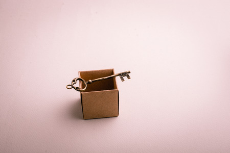 Retro style key on a brown empty boxの写真素材
