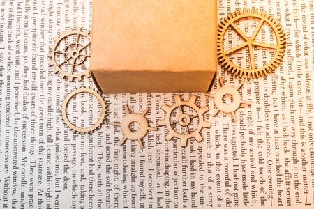 Wooden cogwheels around  box as Industry concept concept