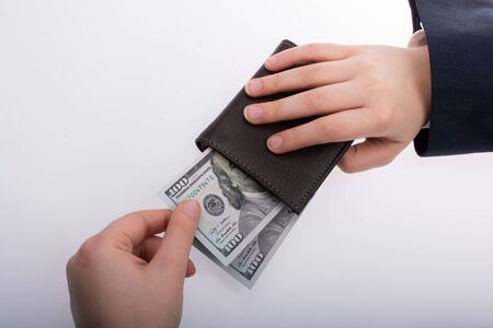 Businessman with dollar banknotes and  wallet on white background