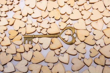 Retro  style heart shaped key on wooden hearts