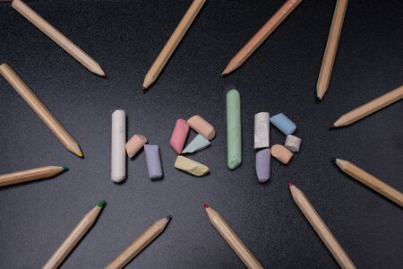 Help word written incoloured chalk on a black chalkboard.の写真素材