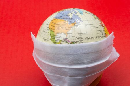 Planet Earth with face mask.  World medical concept.の写真素材