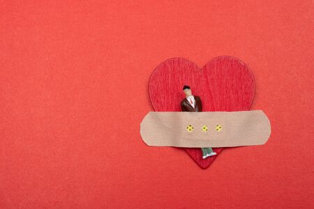 Man figurine on heart icon, Love and Valentines day concept.