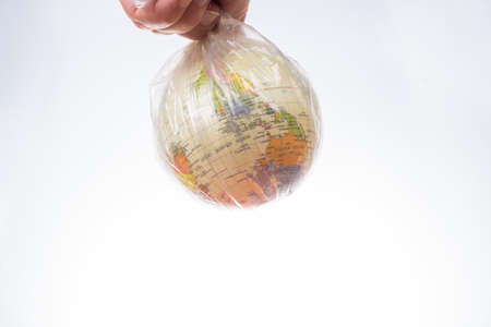 World globe in plastic bag isolated on white background