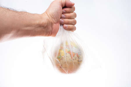 World globe in plastic bag isolated on white backgroundの写真素材