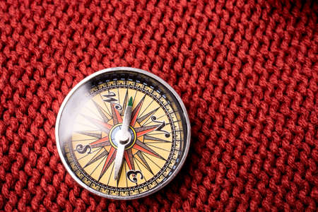 Compass tool on  red texture fabric