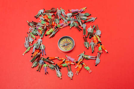Colorful diverse miniature people figurines make crowd on ground