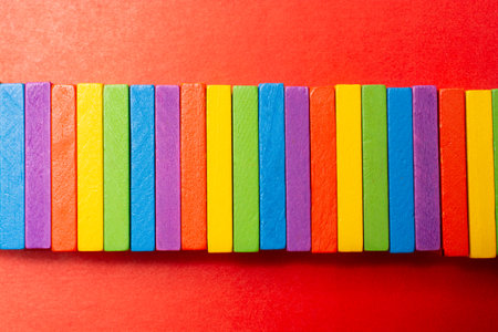 Colorful dominoes. Rainbow colored chain reaction.