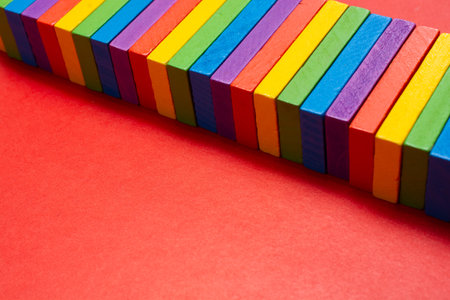 Colorful dominoes. Rainbow colored chain reaction.